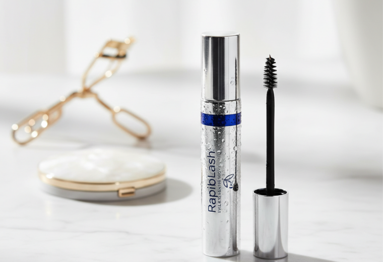 alt_text: RapidLash Eyelash Serum showcased on a chic vanity with beauty tools, exuding luxury and elegance.